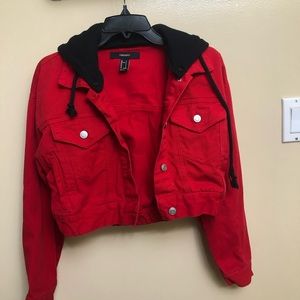 Small, cropped red denim jacket with a black hood.